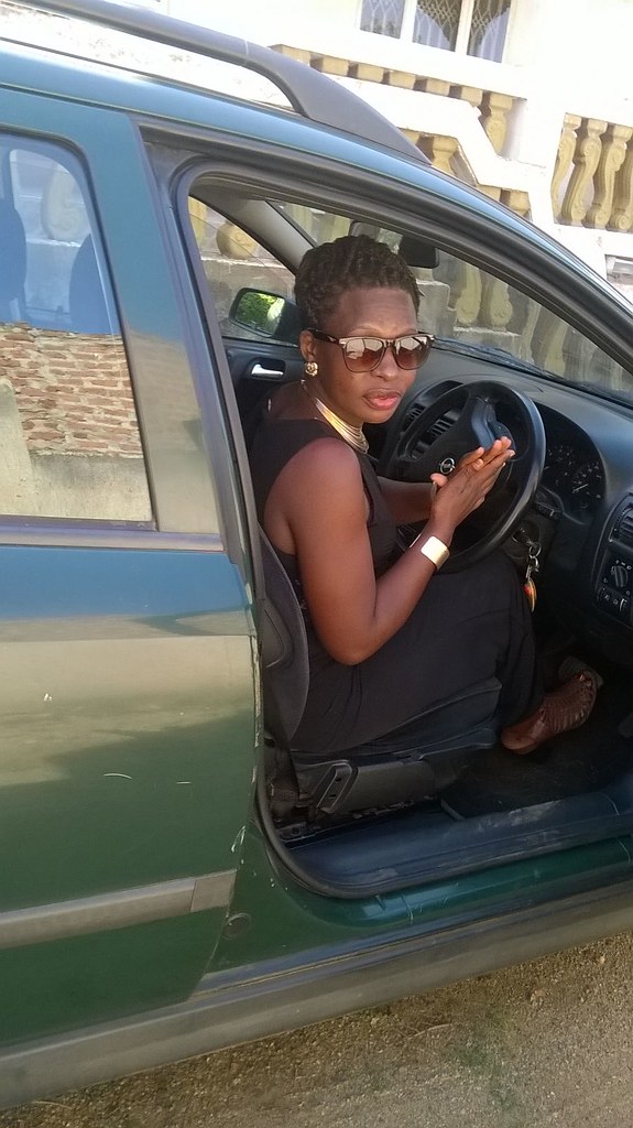 A professional driver from Entebbe Car Hire welcomes a passenger outside Entebbe International Airport.